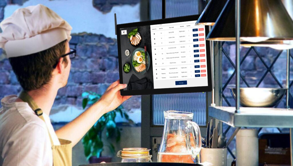 Chef using tablet in restaurant kitchen for online ordering management, ai automation and restaurant management